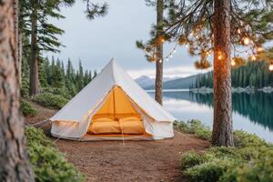 Cozy glamping tent with warm lighting set by a serene lake surrounded by tall trees and mountains, creating a peaceful outdoor retreat atmosphere for relaxation and adventure photo