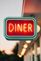 Neon diner sign glowing brightly at twilight, showcasing retro design with vibrant colors, inviting atmosphere, and nostalgic charm for diners and food lovers photo