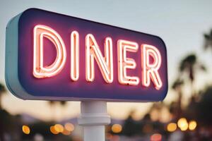 Neon diner sign illuminated at dusk, showcasing vibrant colors against a blurred background of palm trees and city lights, creating a nostalgic atmosphere for diners and visitors photo