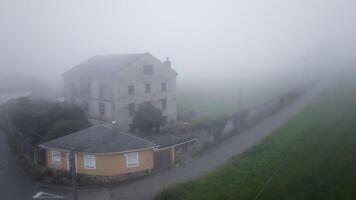 Fog enveloping an old stone house in the countryside creates a mysterious and eerie atmosphere video