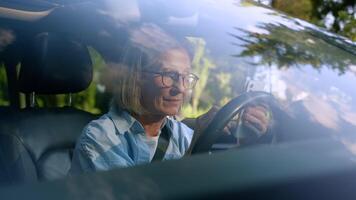 Upset unhappy disappointed Caucasian elderly aged woman female senior mature car auto driver sit inside automobile hold mobile phone browsing social media online app fail losing game negative reaction video