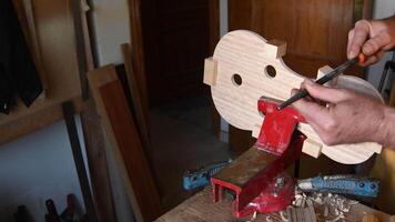 Luthier working in a new violin or viola in the workplace p video