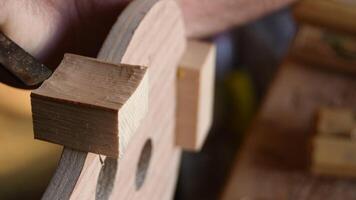 Luthier working with a chisel in the structure of a new violin or viola video