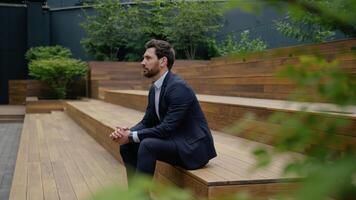 Caucasian businessman adult guy male entrepreneur on stairs outdoors wait dating in city outside smiling business man waiting meeting check time looking at wristwatch clock deadline punctual date walk video