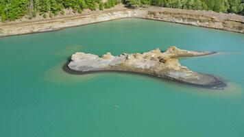 Drone view of the turquoise lake formed as a result of mining waste video