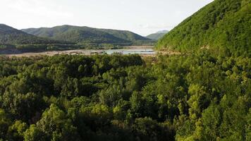 Drone view of a dam with a turquoise lake video
