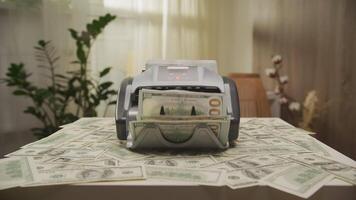 Money counting machine processing large stacks of cash video