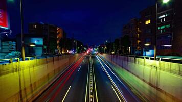 A night timelapse of the city street at the downtown in Setagaya Tokyo wide shot tilt video