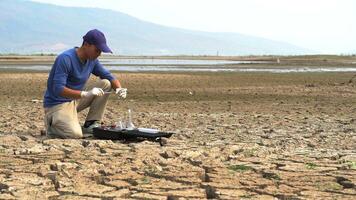 asian scientist analyzings an water and soil to find solutions of soil deterioration problems video