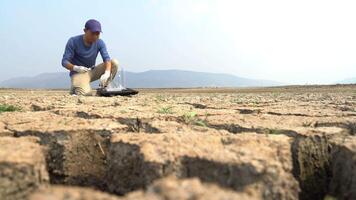 asian scientist analyzings an water and soil to find solutions of soil deterioration problems. video