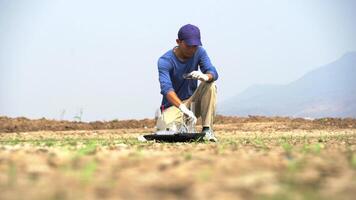asian scientist analyzing a soil and an water to find solutions of soil deterioration problems. video