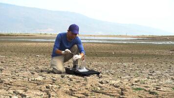 asian scientist keeping a soil sample to find solutions of soil deterioration problems. video
