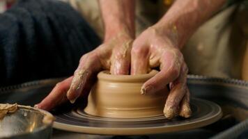 Close up hands skilled craftsman man sculpt modeling shape clay pot jug male handmade potter pottery wheel workshop hobby ceramics vase craft small business owner art arms working earthenware ceramist video