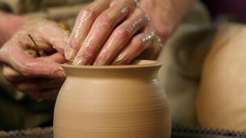 Close up man master hands form modeling shape vase pot clay art process making jug craftsman ceramic male handmade hobby small business owner workshop studio potter pottery wheel earthenware artisan video