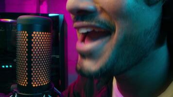 Close up Arabian Indian Latina man speaking male guy talking microphone streaming online gamer streamer cyber sport playing computer games broadcasting radio host blogger presenter influencer vlogger video