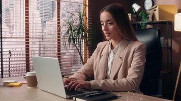 Happy cheerful smiling Caucasian woman female lady businesswoman office worker business person entrepreneur employee working laptop typing keyboard computer looking at camera show okay ok good indoors video
