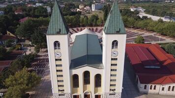 Close up view of the church of Medjugorje symbol of the city and of the apparition of the Madonna. Aerial view of the landmark structure of prayer and pilgrimages travelling Bosnia and Herzegovina video