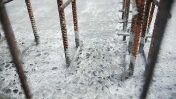 Reinforcing steel bars embedded in cured concrete video