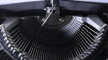 Letters hitting the paper while typing in an old qwerty typewriter with sound video