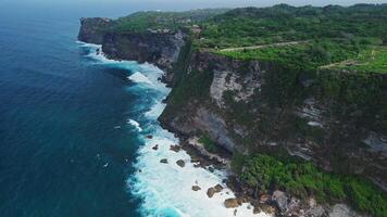 Uluwatu coastline with cliffs and waves in Bali. Scenic aerial view landscape in Bukit video