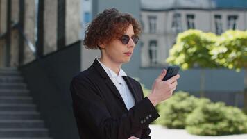Businessman looking for location uses geolocation GPS maps application on mobile phone find way road video