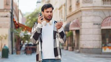 Stressed Indian man talking screaming on mobile phones having conflict quarrel complaint on street video