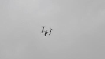 The Flying helicopter dron on a background of white clouds. video