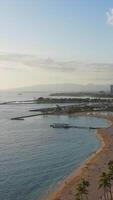 Scenic view of Honolulu s coastline, Fort DeRussy Beach with palm trees, sandy shore, and Diamond Head mountain in the background video