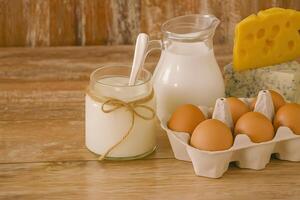 Dairy Products Milk Yogurt Eggs and Cheese on a Wooden Surface photo