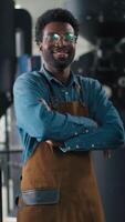 Multinational confident happy Caucasian African men coffee factory workers folding hands gesture smile looking camera small business roasting beans production machine preparation beverage manufacture video