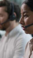 Close up smiling multiethnic team group operators diverse callcenter workers headset microphone consulting customer online service sales Indian business woman Caucasian African assistant call center video