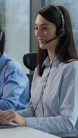 Three diverse business people multiethnic Indian women African man call center service operators work indoor office talking client headset on computer sales agents support sell online at callcenter video