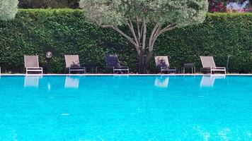 Sunbeds and Umbrellas Around the Pool at the Hotel. Hotel with Swimming Pool With Blue Clear Water and Nature. Palms. Loungers for Rest. video