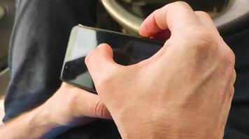 A Man Plays a Computer Game on a Smartphone. The Guy After Work Sits on a Mobile Phone in the Online World, Connects Through Various Applications for Information Exchange, Games. video