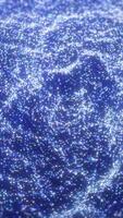 Dense glowing field of small blue and white particles forming an abstract shimmering digital texture video