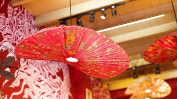 Red lanterns hang in a warmly lit restaurant, creating a vibrant and inviting atmosphere with intricate wall patterns video