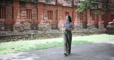 Handheld shot, Young woman is enjoying a quiet walk while taking pictures of the surrounding nature, Enjoy holiday travel. video