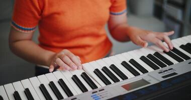 Close up shot, Woman's hands are practicing playing the piano keyboard with relaxation and happiness in the living room at home. video