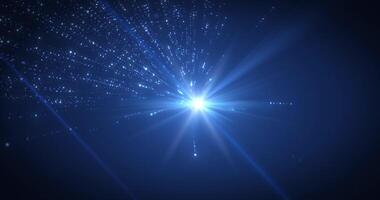 Radiant blue light burst with sparkling particles and glowing rays on dark background. Perfect for sci-fi, space, energy, or futuristic digital effects and backgrounds. Seamless looping animation video