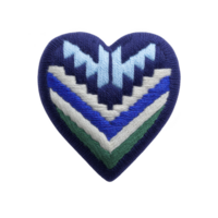 Heart shaped patch with geometric pattern in blue, white, and green, featuring zigzag designs. embroidery creates textured appearance, adding depth and interest to design png
