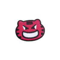 Red embroidered patch features cartoonish, angry face with wide grin and bold black outlines, conveying playful yet fierce expression png