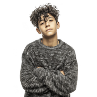Curly haired teen boy in grey sweater smiling and posing confidently isolated on transparent background png