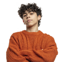 Teenage boy in fuzzy orange sweater smiling casually isolated on transparent background png