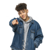 Teen boy in denim jacket pointing toward camera with confident expression isolated on transparent background png