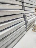 Close-up, stack of glued book blocks prepared for binding in a printing house, vertical photo