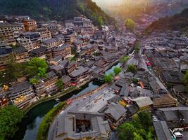 An Aerial view of Xijiang Miao Village, also known as Xijiang Qianhu Miao Village, is the largest Miao ethnic village in the world, located in Guizhou, China. photo