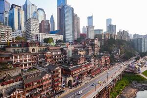 Chongqing, China-APR 02, 2025-Cityscape of the famous downtown shopping complex Hongyadong with illuminated bridge and highrise building in Chongqing photo