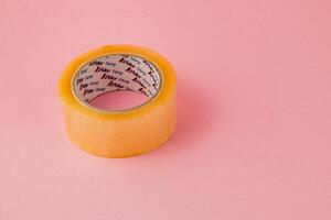 Lviv Ukraine 05.06.25 Clear adhesive tape on a pink background for crafting needs photo
