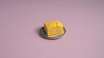a delecta ble pile of crea m puffs dusted with powdered suga r on a vinta ge pla te a ga inst pink ba ckdrop photo