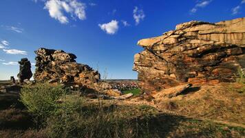 Rock formations divide landscape view toward Weddersleben, Germany village at golden hour photo